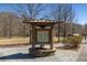 Park sign with hours and information in a serene outdoor setting at 2564 Lulworth Ne Ln, Marietta, GA 30062