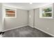 Bedroom featuring gray carpet, two windows, neutral walls, and white trim at 3524 Brookfield Ln, Decatur, GA 30032