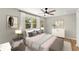 Serene bedroom with neutral tones, hardwood floors, large window, and decorative artwork at 3524 Brookfield Ln, Decatur, GA 30032