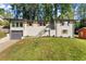 Charming home featuring a well-manicured lawn, painted brick, and tasteful landscaping at 3524 Brookfield Ln, Decatur, GA 30032