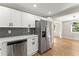 Bright, airy kitchen with stainless steel appliances, white cabinets, and open layout at 3524 Brookfield Ln, Decatur, GA 30032