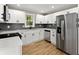 Modern kitchen with stainless appliances, sleek white cabinets, and modern subway tile backsplash at 3524 Brookfield Ln, Decatur, GA 30032