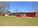 Large backyard with well-maintained lawn, complemented by patio seating for outdoor relaxation at 3528 Highway 42 S, Locust Grove, GA 30248