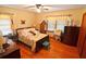 Bedroom with ceiling fan, hardwood floors, and two windows at 3528 Highway 42 S, Locust Grove, GA 30248