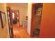 Hallway view of closet with clothing and adjacent living room at 3528 Highway 42 S, Locust Grove, GA 30248