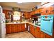 Rustic kitchen featuring wood cabinetry, a tile backsplash, and unique vintage appliances at 3528 Highway 42 S, Locust Grove, GA 30248
