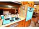 Retro kitchen featuring a blue oven, wood cabinets, and a tile countertop at 3528 Highway 42 S, Locust Grove, GA 30248