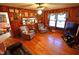 Warm and inviting living room with wood-paneled walls, hardwood floors, and comfortable seating at 3528 Highway 42 S, Locust Grove, GA 30248