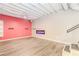 Finished basement featuring plank flooring, a modern electric fireplace, and a statement red accent wall at 1019 Walnut Creek Dr, Woodstock, GA 30188