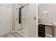 Modern bathroom with a glass enclosed shower, tiled walls, neutral tones, and plank flooring at 1019 Walnut Creek Dr, Woodstock, GA 30188