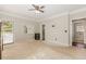 Spacious bedroom with carpet flooring, lighted ceiling fan, and a door leading to the outdoor deck at 1019 Walnut Creek Dr, Woodstock, GA 30188