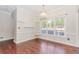 Cozy dining area with hardwood floors, classic chandelier and large windows showcasing neighborhood views at 1019 Walnut Creek Dr, Woodstock, GA 30188