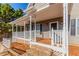 Inviting front porch features stone steps, classic columns, and ample space for relaxing and entertaining at 1019 Walnut Creek Dr, Woodstock, GA 30188