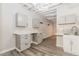 Basement kitchenette featuring modern countertops, sleek cabinetry, stylish plank flooring and mosaic backsplash at 1019 Walnut Creek Dr, Woodstock, GA 30188