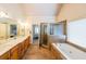Spacious bathroom featuring a soaking tub, separate shower, double sinks, and tile flooring at 103 Gold Springs Ct, Canton, GA 30114