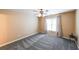 Simple carpeted bedroom with a ceiling fan and a window providing natural light at 103 Gold Springs Ct, Canton, GA 30114