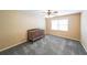 Bright bedroom with a ceiling fan, a large window and gray carpet with a wooden baby crib at 103 Gold Springs Ct, Canton, GA 30114