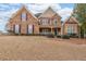 Inviting two-story home with a combination stone and siding exterior and manicured landscaping at 103 Gold Springs Ct, Canton, GA 30114