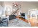 Spacious living room with tall ceilings, hardwood floors, staircase, and an open concept design at 103 Gold Springs Ct, Canton, GA 30114