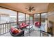 Inviting screened porch with comfortable seating, ceiling fan and view of the surrounding neighborhood at 103 Gold Springs Ct, Canton, GA 30114