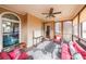 Relaxing screened porch featuring cozy furniture, a ceiling fan, and serene views at 103 Gold Springs Ct, Canton, GA 30114