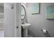 Bathroom features a pedestal sink, an oval mirror, and artwork hung on the wall at 21 Samuel Nw Way, Cartersville, GA 30121