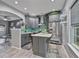 Stylish eat-in kitchen with modern gray cabinetry, stainless appliances, and adjacent living room view at 21 Samuel Nw Way, Cartersville, GA 30121