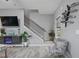 Comfortable living room with modern fireplace, sleek floors, and open staircase at 21 Samuel Nw Way, Cartersville, GA 30121
