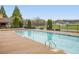 Community pool with diving board surrounded by lush landscaping and ample deck space for lounging at 21 Samuel Nw Way, Cartersville, GA 30121