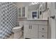 Bathroom with white vanity, mirror, and blue patterned shower curtain offering a fresh, clean look at 5159 Roswell Rd # 7, Sandy Springs, GA 30342