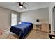 Bedroom with blue bedding, neutral walls, ceiling fan, and a window providing natural light at 5159 Roswell Rd # 7, Sandy Springs, GA 30342