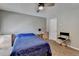 Bedroom features light neutral walls, ceiling fan, blue bedding, and a window bringing in natural light at 5159 Roswell Rd # 7, Sandy Springs, GA 30342