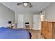 Bright bedroom featuring a ceiling fan, side table, and vintage dresser at 5159 Roswell Rd # 7, Sandy Springs, GA 30342