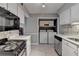 Kitchen with white cabinets, stainless dishwasher, and adjacent laundry area at 5159 Roswell Rd # 7, Sandy Springs, GA 30342
