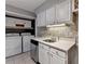 Laundry area featuring a sink, white cabinets, and washer/dryer hookups at 5159 Roswell Rd # 7, Sandy Springs, GA 30342