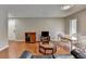 Open living area with hardwood floors, dining table, entertainment center, and access to other rooms at 5159 Roswell Rd # 7, Sandy Springs, GA 30342