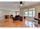 Open living space with hardwood floors, leather sofa, and view of dining area and multiple windows at 5159 Roswell Rd # 7, Sandy Springs, GA 30342