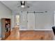 Living room features a sliding barn door, hardwood floors, and a bookshelf adding character to the space at 5159 Roswell Rd # 7, Sandy Springs, GA 30342