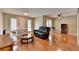 Spacious living room featuring hardwood floors, a black leather sofa, and natural light from the windows at 5159 Roswell Rd # 7, Sandy Springs, GA 30342