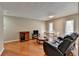 Open living room with hardwood floors, neutral walls, and a view of the dining area and entertainment center at 5159 Roswell Rd # 7, Sandy Springs, GA 30342