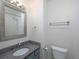 Bathroom with granite countertop and a framed mirror above the sink and toilet, towel rack, and tissue holder at 2158 Berryhill Se Cir, Smyrna, GA 30082