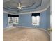 Spacious bedroom with plush carpet, ample natural light, and a decorative tray ceiling at 2158 Berryhill Se Cir, Smyrna, GA 30082