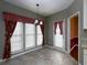 Bright breakfast nook featuring tile floors, three large windows, and a classic chandelier at 2158 Berryhill Se Cir, Smyrna, GA 30082