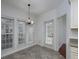 Inviting dining area bathed in natural light, complemented by a stylish chandelier and easy outdoor access at 2158 Berryhill Se Cir, Smyrna, GA 30082
