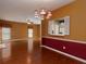 Dining room with hardwood floors, decorative chandelier, and open view to the living area at 2158 Berryhill Se Cir, Smyrna, GA 30082