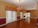 Dining area with hardwood floors, stylish chandelier, and view of the living area at 2158 Berryhill Se Cir, Smyrna, GA 30082