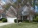 A two-story home with brick and siding exterior, lush front lawn, and a two-car garage, shaded by mature trees at 2158 Berryhill Se Cir, Smyrna, GA 30082