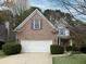Charming two-story brick home featuring a two-car garage and well-maintained landscaping and a covered front porch at 2158 Berryhill Se Cir, Smyrna, GA 30082