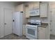 Efficient kitchen featuring white appliances, cabinetry and tiled floor at 2158 Berryhill Se Cir, Smyrna, GA 30082
