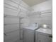 Functional laundry room with washer, dryer, and wire shelving for organized storage at 2158 Berryhill Se Cir, Smyrna, GA 30082